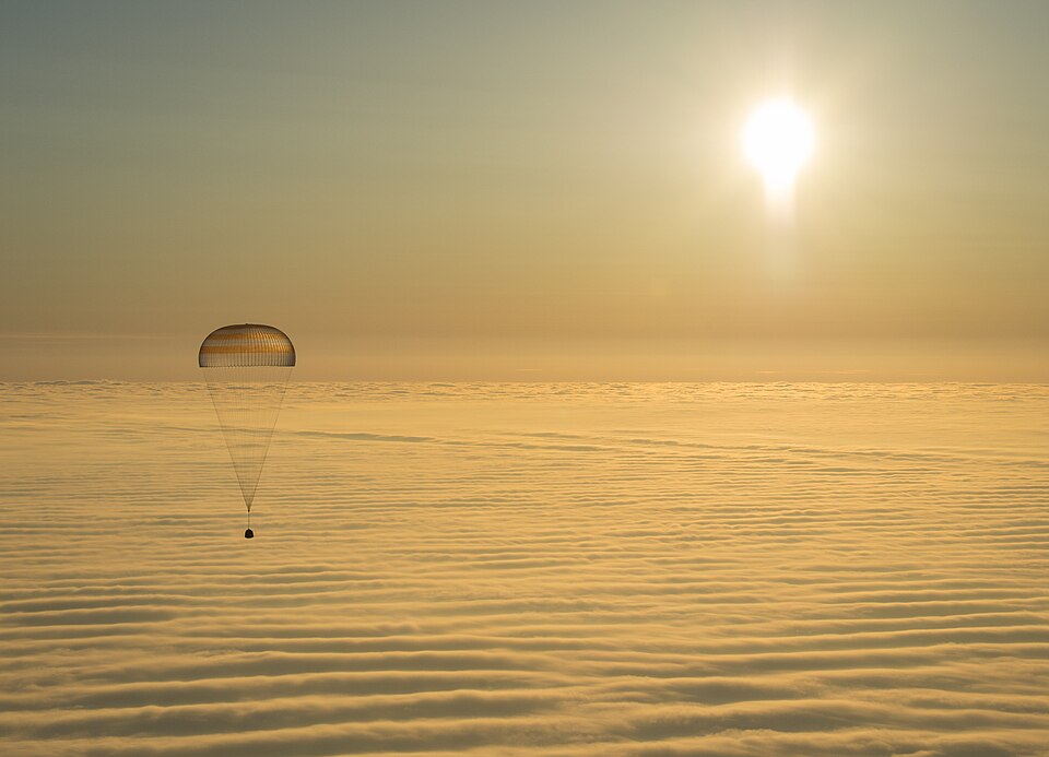 On March 12, 2015, shortly after local sunrise over central Asia, this Soyuz TMA-14M spacecraft floated over a sea of golden clouds during its descent by parachute through planet Earth's dense atmosphere. On board were Expedition 42 commander Barry Wilmore of NASA and Alexander Samokutyaev and Elena