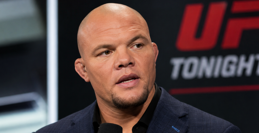 UFC analyst and former fighter Anthony Smith holding a UFC microphone during a studio broadcast.