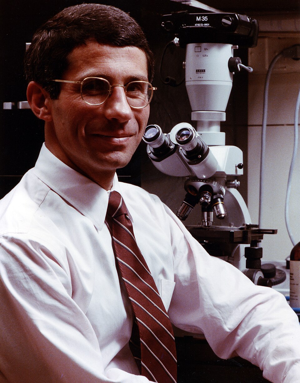 Dr. Anthony Fauci in front of a microscope, 1984. Credit: NIAID