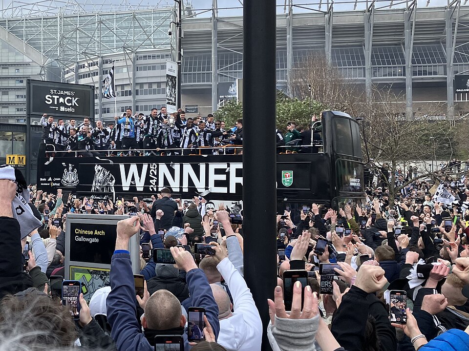 The Newcastle United team display the League Cup on an open top bus parade through the city centre.
