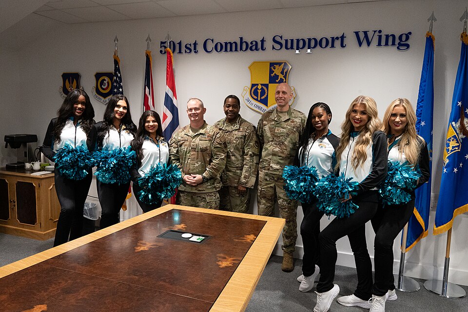Members of the 501st Combat Support Wing leadership team pose with the Jacksonville Jaguars Roar Cheerleader Squad at RAF Fairford, England, Oct. 9, 2024. The cheerleaders were invited to interact with Airmen and leadership, tour the base, eat at the dining facility and learn about Fairford’s herita