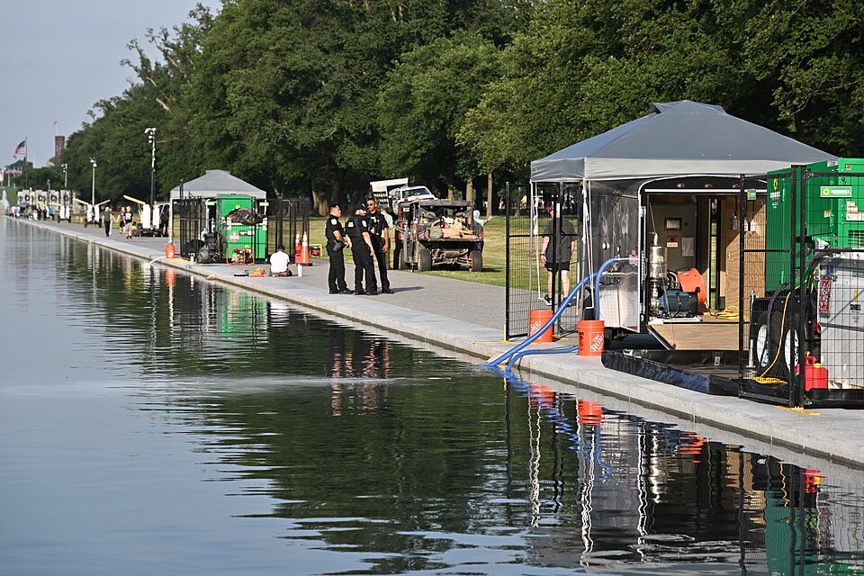 As part of the effort to clear the algae bloom out of the Lincoln Memorial Reflecting Pool, "high-tech nanobubble ozone technology" was deployed from these trailers under the canopies and powered by the green electric generators. Hoses run into the reflecting pool to deliver to treatment. Park polic
