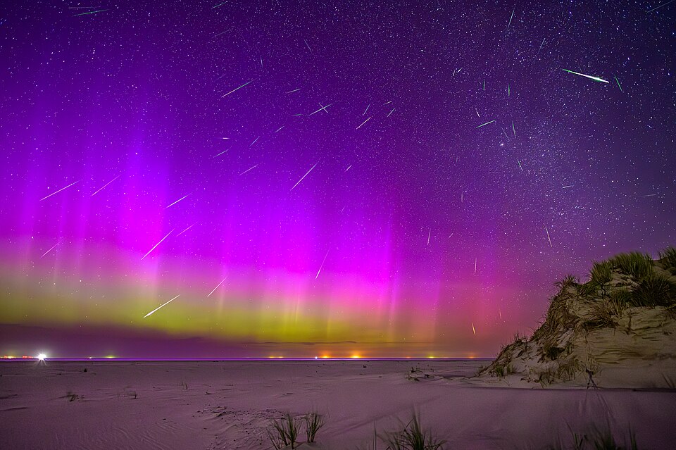 Aurora and perseids seen at the beach of Norderney, Germany. The image is a composite of 64 individual exposures of meteors, one of these images was used as a background. The frames were taken in the night from 12 to 13 August 2024 with shooting stars from 23:20 to 03:27 (CEST), the background image