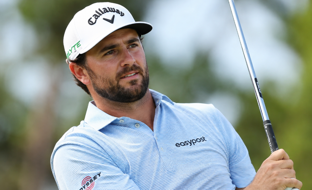 Professional golfer Caleb Wassmer watches his shot after swinging a golf club during an outdoor tournament.