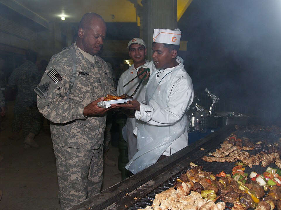 Command Sgt. Maj. Willie Tennant, the senior non-commissioned officer of the 3rd Sustainment Command (Expeditionary), based out of Fort Knox, Ky., grabs some dinner while attending a going away party for Command Sgt. Maj. Marvin Hill, the Multi National Forces-Iraq senior non-commissioned officer in
