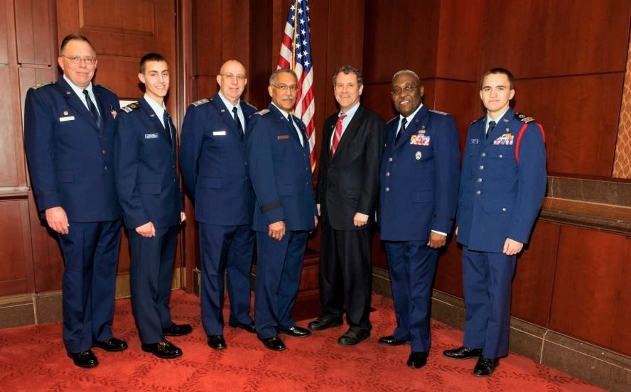 Maj Paul Bronsdon, C/Maj Joshua Schoettelkotte, Col Gregory Mathews, Maj Gen Charles Carr, Senator Sherrod Brown (D-OH), National Chaplain Colonel J. Delano Ellis, C/Capt Jared Mohler. Source: U.S. Senate Photographic Studio.