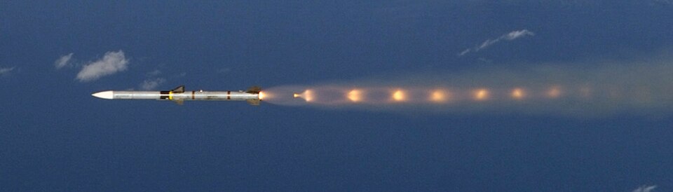 This F-22A Raptor #03-4058 from the 27th Fighter Squadron "Fighting Eagles" located at Langley Air Force Base, Virginia, fires an AIM-120 Advanced Medium Range Air-to-Air Missile (AMRAAM) and an AIM-9M sidewinder heat-seeking air-to-air missile at an BQM-34P "Fire-bee" subscale aerial target drone o
