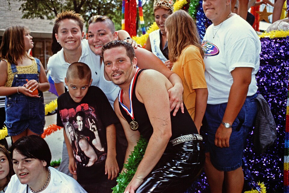 Participants in the 1999 Gay Pride parade at the State Capitol in Madison, Wisconsin.  The parade was small in comparison with other years, not just because of the inclement weather, but because of a heated dispute in 1998 about whether members of the Madison Police Department would be allowed to pa