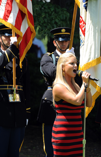 PHOTO CAPTION: Jessica Simpson is surrounded by the Stars &amp; Stripes and the U.S. Army Flag as she sings "The Star-Spangled Banner" during the opening ceremony of the AT&amp;T National PGA Tour event July 1 at Congressional Country Club in Bethesda, Md. Simpson recently performed for troops in Ir