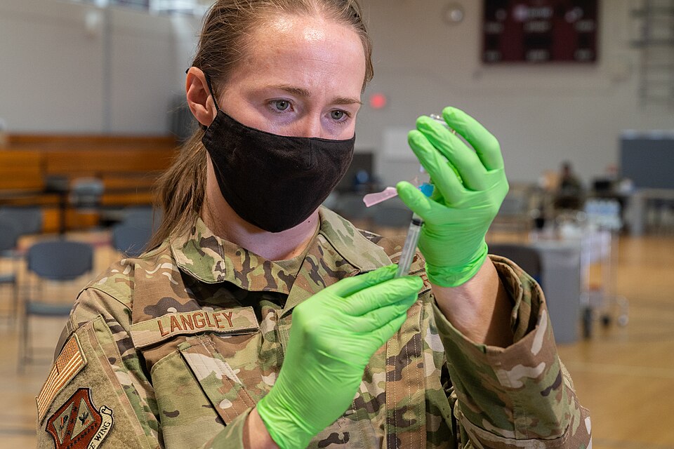 U.S. Air Force Maj. Rachel Langley, 310th Space Wing flight surgeon, fills a syringe with Moderna COVID-19 vaccine at the base gym, Peterson Air Force Base, Colorado, April 11, 2021. (U.S. Air Force photo by Staff. Sgt. Marko Salopek)