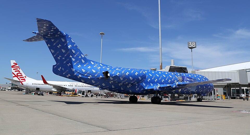 Alliance Airlines Fokker F70 wrapped up in Powerball wrapping paper at Brisbane Airport