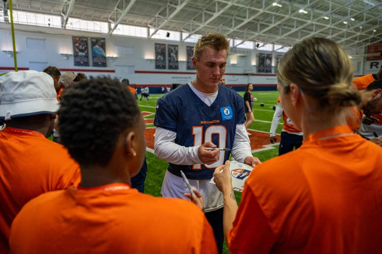 Bo Nix, Denver Broncos quarterback, signs autographs for service members at the USAA Salute to Service Training Camp, at Broncos Park, Englewood, Colorado August 21, 2025.