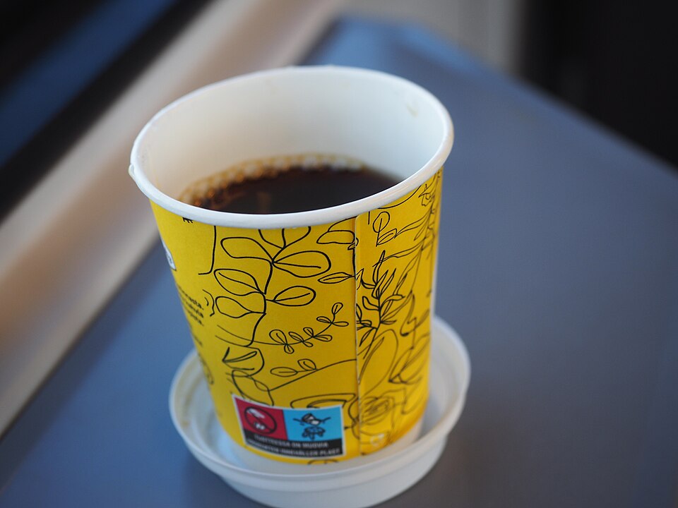 Coffee in a disposable cardboard cup bought from an R-kioski convenience store on an HSL commuter train in the Helsinki capital area in Finland on a March morning.