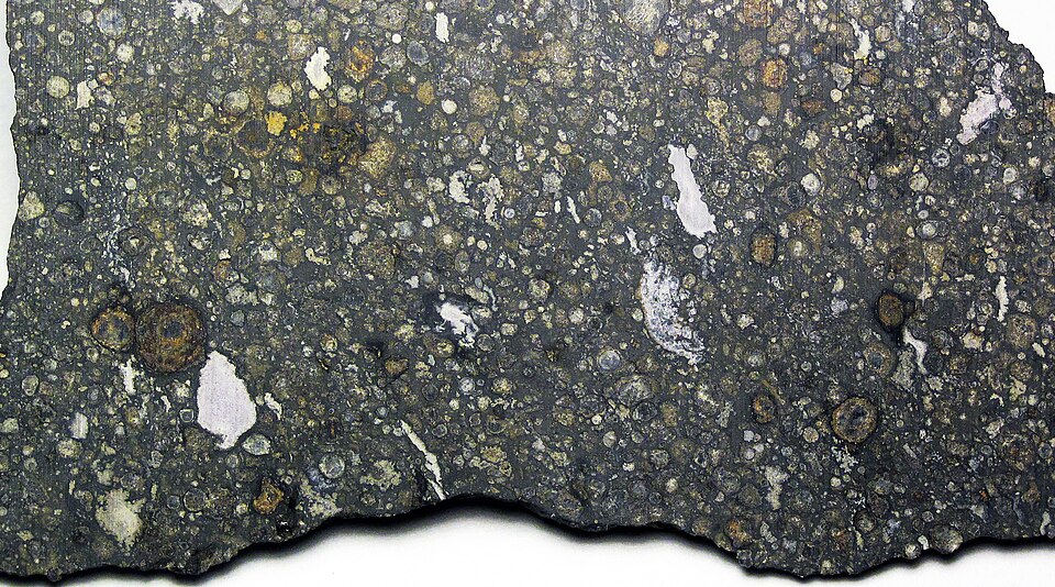 Carbonaceous chondrite - slice of the Allende Meteorite from Mexico.
Carbonaceous chondrites are dark gray to blackish-colored chondrite meteorites with a relatively carbon-rich matrix.  The first large sampling of carbonaceous chondrites available to meteoriticists came with the 1969 fall of the Al