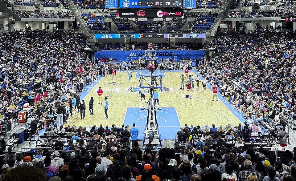 Packed basketball stadium with Sky blue court markings