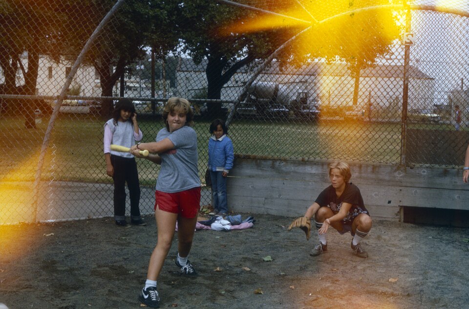 Children playing baseball in an unidentified park in Seattle, Washington, U.S., circa 1980s.