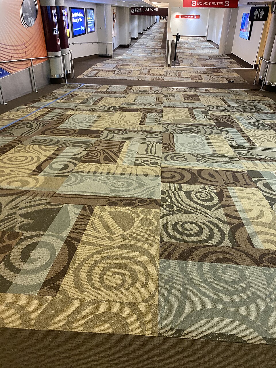 A hallway within Nashville International Airport, carpeted entirely using the old design.