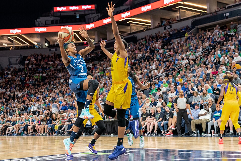 Danielle Robinson drives to the basket as Nneka Ogwumike guards her in the Minnesota Lynx vs Los Angeles Sparks game at Target Center, the Lynx won the game 83-72