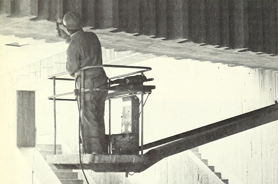 A worker finishes concrete details at Balboa Park station in 1970