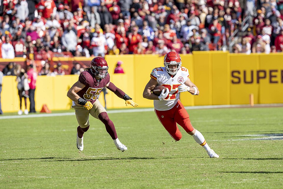 Kansas City Chiefs tight end Travis Kelce being pursued by Washington Football Team linebacker Cole Holcomb in a game at FedEx Field in Landover, Maryland, on October 17, 2021.