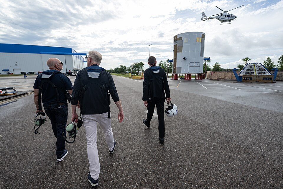 NASA Administrator Jared Isaacman, right; Jeff Bezos, founder, Blue Origin, left; and Dave Limp, chief executive officer, Blue Origin, center, are seen ahead of a helicopter flight, Friday, May 29, 2026, at Blue Origin’s Rocket Park in Merritt Island, Fla. The flight surveyed nearby Launch Complex 3