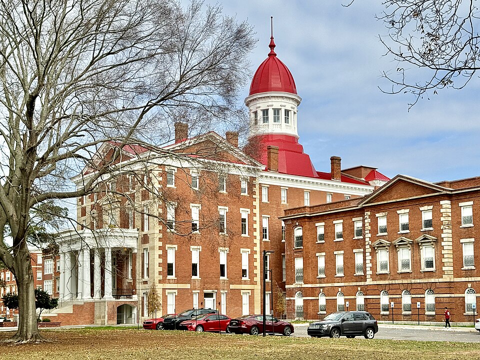 Built between 1858 and 1885, this Renaissance Revival-style building was designed by George E. Walker, Gustavus T. Berg, and Samuel Sloan to serve as the main building of the South Carolina State Hospital, a psychiatric hospital, and was a partial kirkbride plan building, with multiple wards in wing