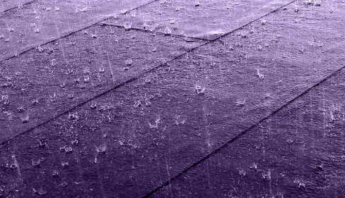 Hard rain on a roof covered with felt and tar paper in Gåseberg, Lysekil Municipality, Sweden. The black and white version has been altered using a monochrome purple filter.