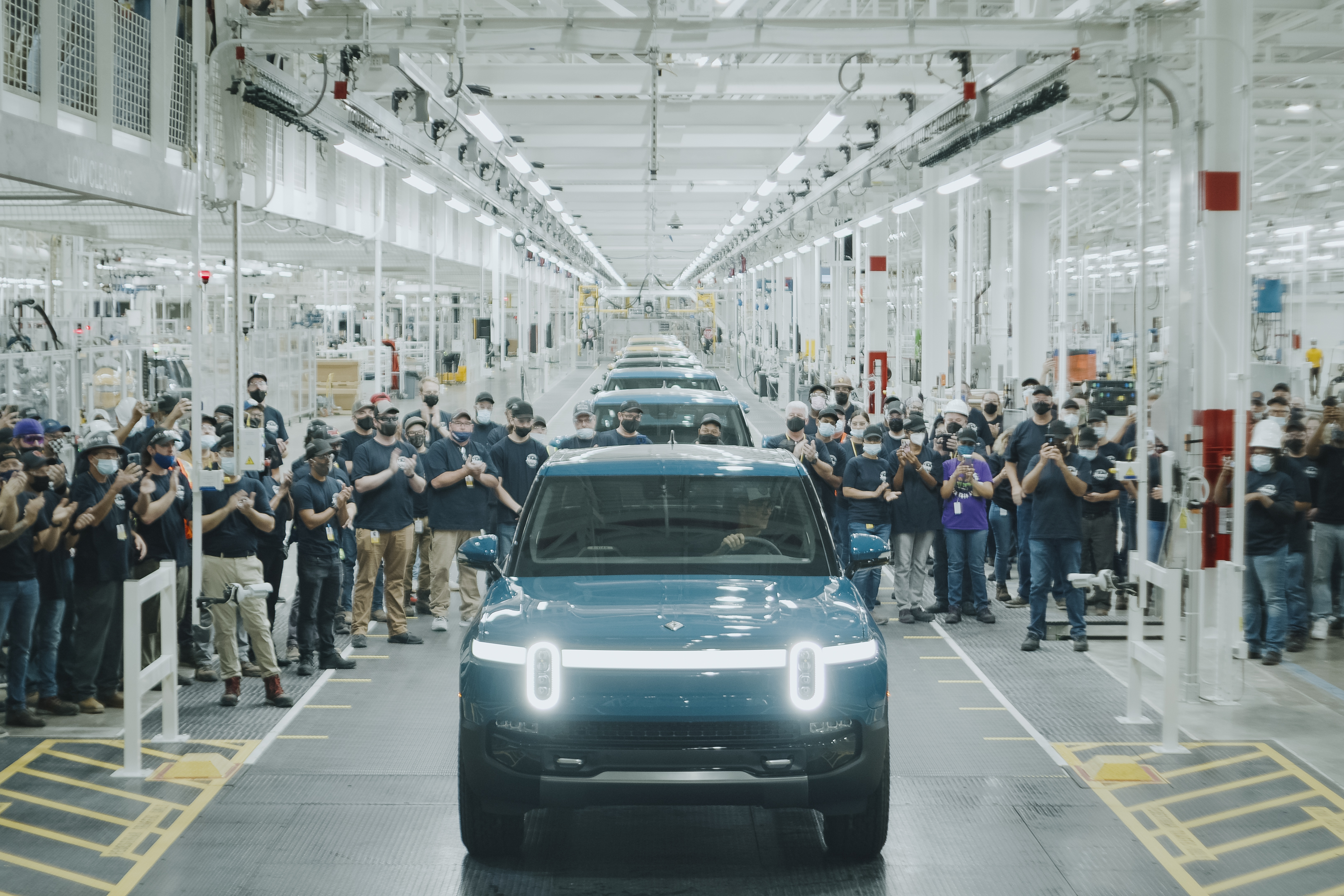 This photo shows the first R1T built for a customer rolling off Rivian's assembly line at their plant in Normal, IL.